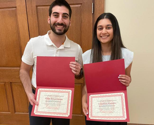 Anushka Parekh and Elias Bouyounes holding awards