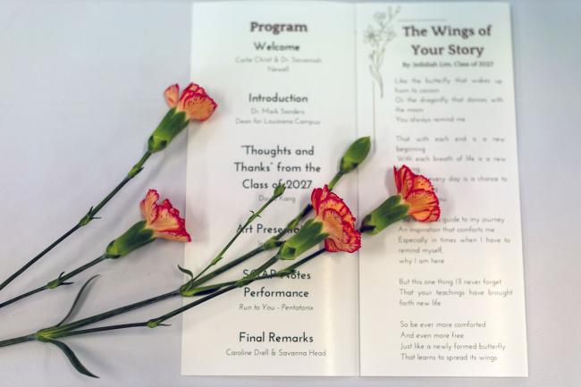 Flowers laying over a program for the donor ceremony