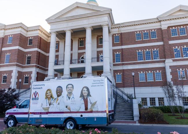 Mobile medical unit parked in front of VCOM-Louisiana building