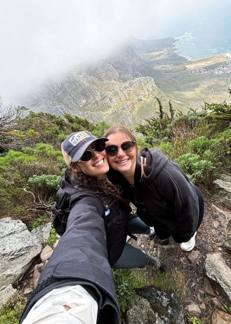 Erin Onken on a hike with mountains in the background