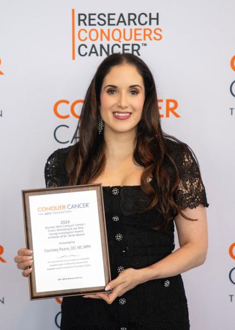 Courtney Pisano posing with an award