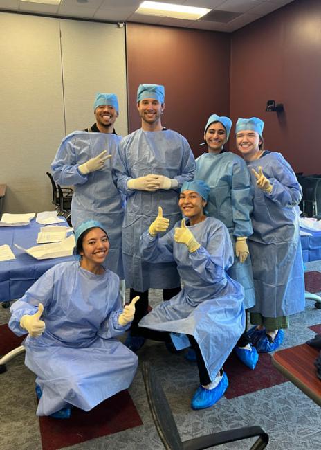 Dana Lewis with others in sugery scrubs