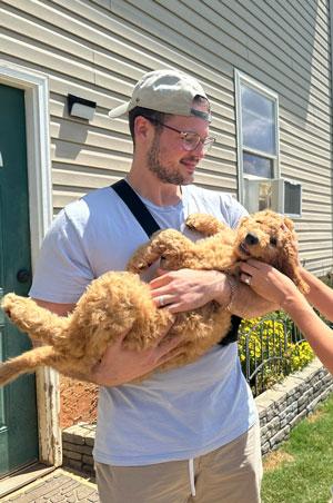 Logan Gardner holding his dog