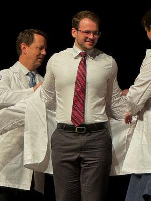 Logan Gardner receiving his white coat