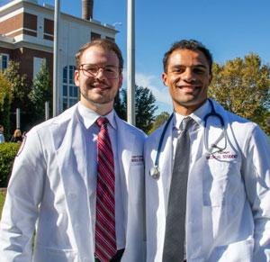 Logan Gardner with fellow student in white coats