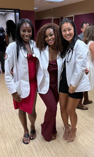Athena Lee with fellow students in white coats