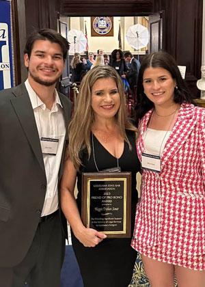 Kade Simar with friends holding an award
