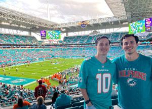 Carlos Jimenez, Jr. at a football game with a friend