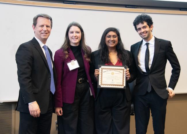 Students and faculty on Research Day posing with an award winner
