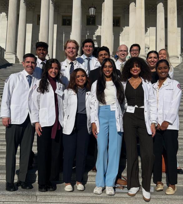 VCOM-Auburn students in white coats smiling