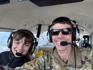 Michael Brisson with his son flying an airplane