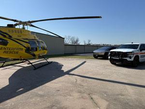 Helicopter parked with other vehicles