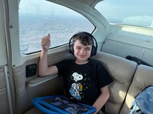 Michael Brisson son in the back seat of an airplane