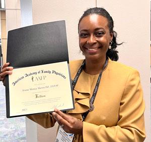 Ariana Martin holding a certificate