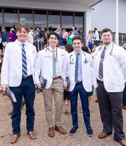 Brennan Medlin and fellow students in white coats