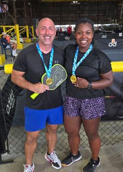 Jamie Rogers and friend holding pickleball rackets