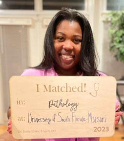 Jamie Rogers holding her match day poster