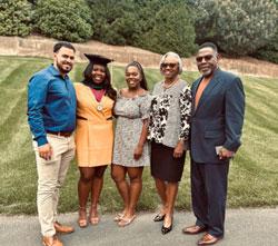 Jamie Rogers with family on graduation day