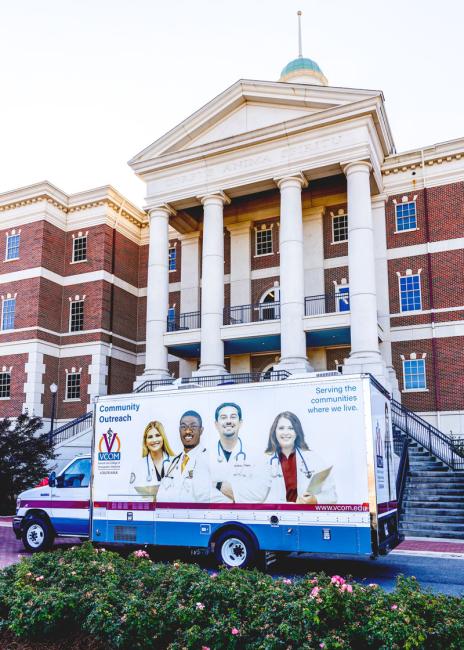 Mobile medical unit parked in front of VCOM-Louisiana campus building