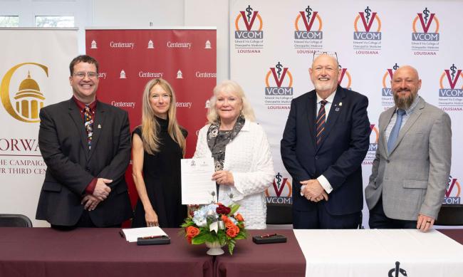 Centenary College and VCOM members smiling and holding signed articulation agreement