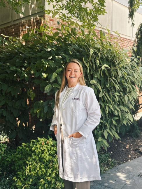 Kristina Alexander, DO smiling in her white coat