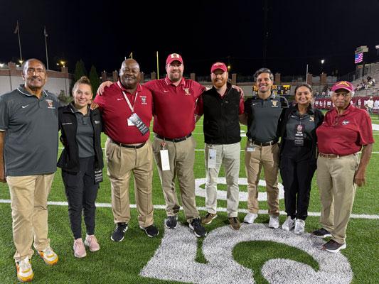 VCOM-Auburn Sports Medicine members standing on a football field