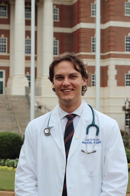 Caleb Van Horn in white coat smiling