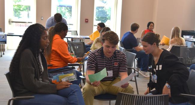 VCOM-Auburn students sitting in a circle talking