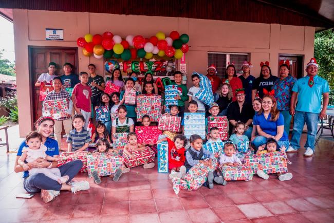 Large group of children in Honduras holding gifts and smiling