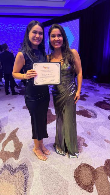 Celesta Prado holding scholarship award