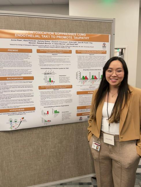 Annie Pham standing in front of her research day poster