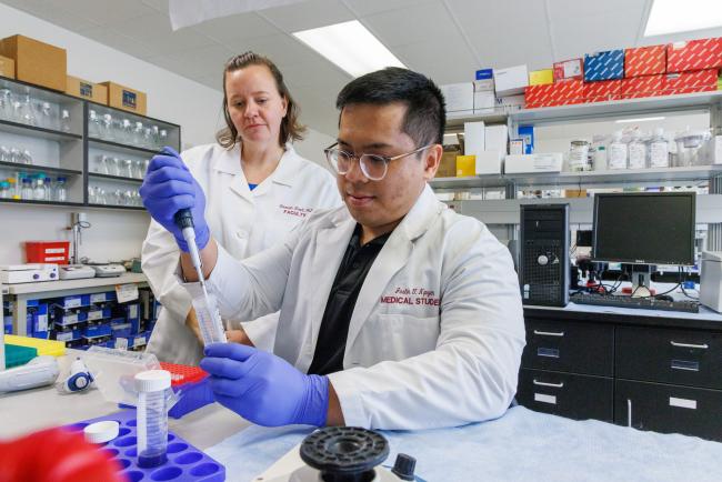 Justin Nguyen working in a lab