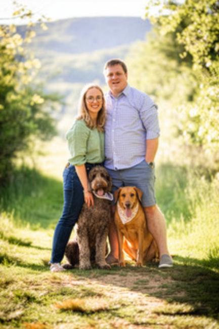Dr. Hannah DePoy-Pratt with her husband and dogs