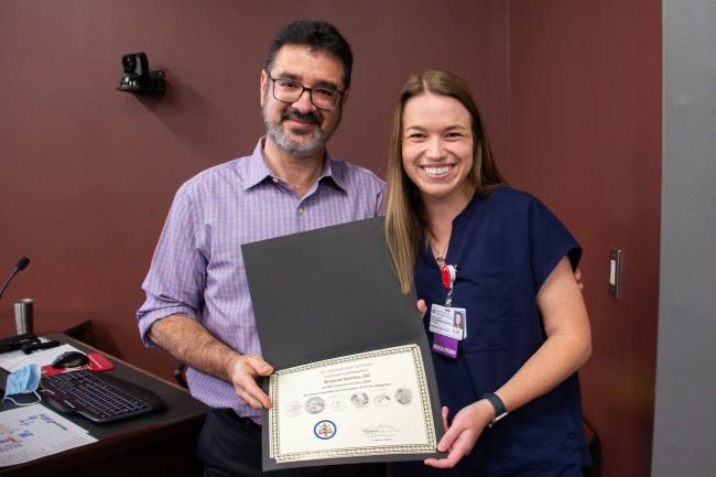 Dr. Sahhar with a medical student smiling
