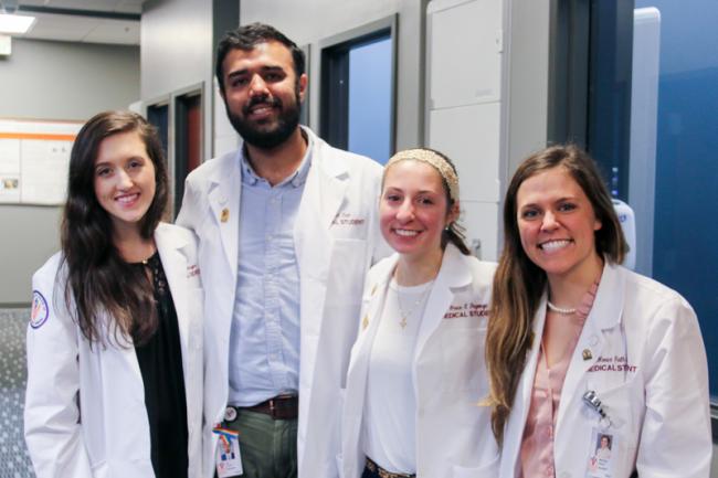 VCOM students in white coats