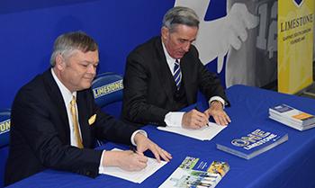 John G. Rocovich with Limestone representative signing documents