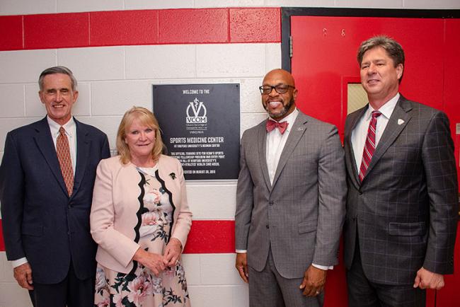 VCOM and Radford University representatives standing in front of sports medicine center