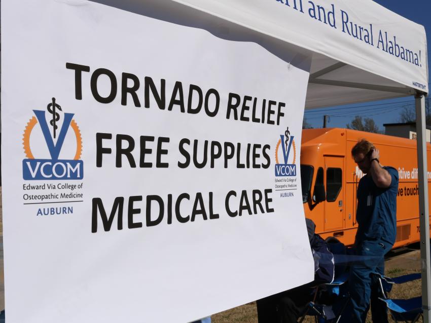 Tent with sign reading "Tornado Relief Free Supplies Medical Care"