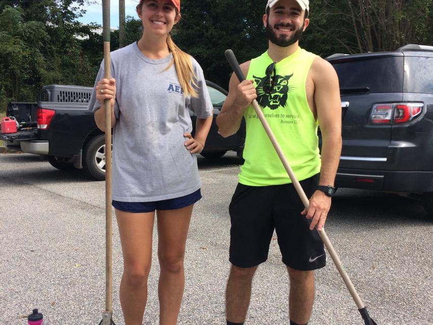Students with rakes outside