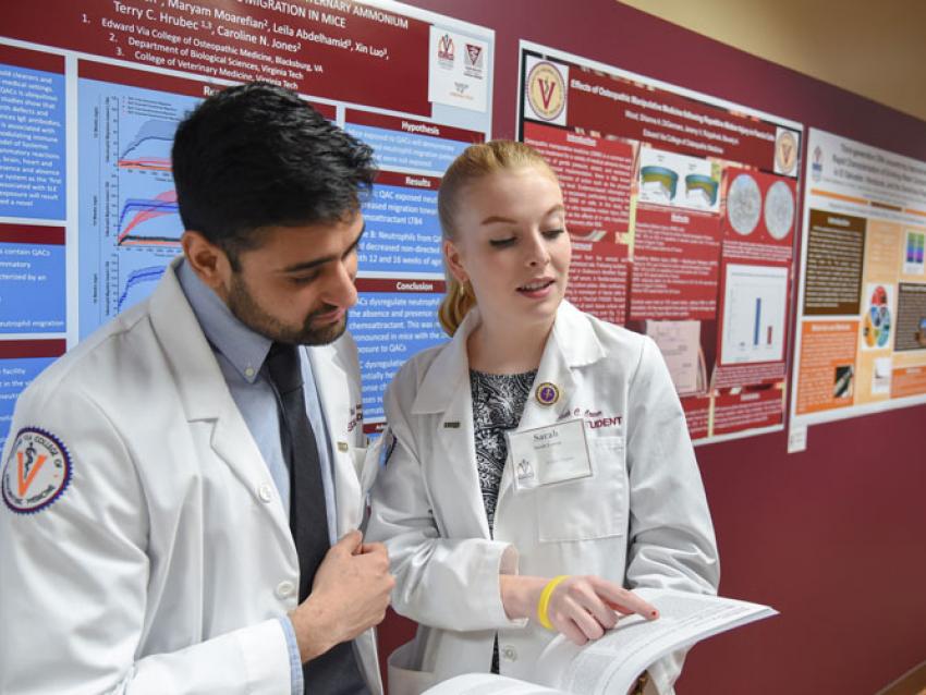 Students in white coats during Research Day