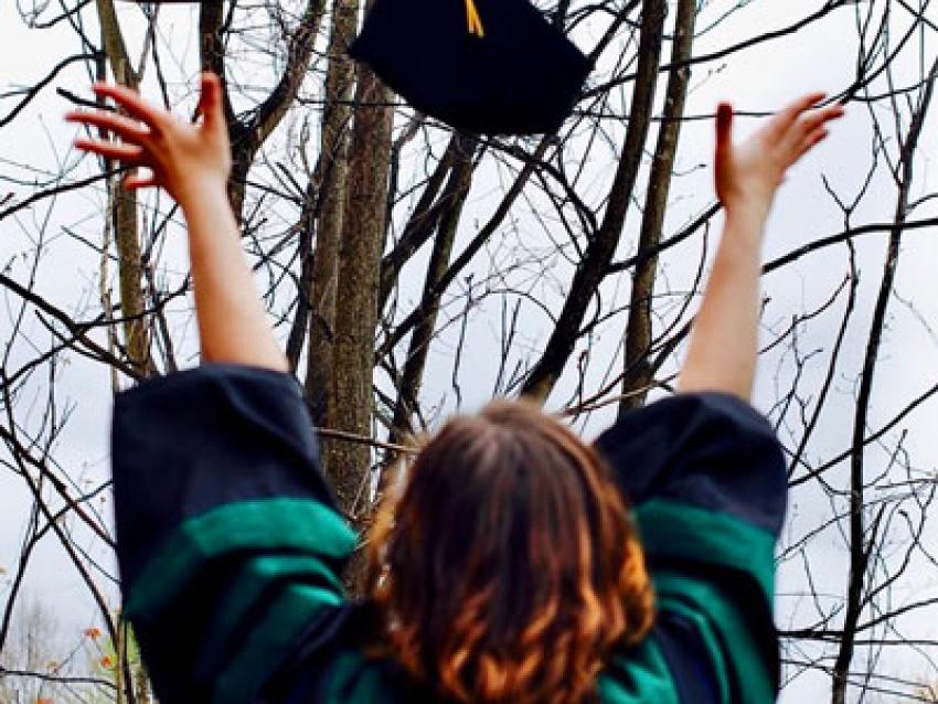 Carolinas Graduate throwing cap