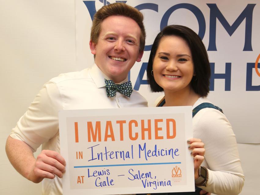 Auburn student holding match day sign