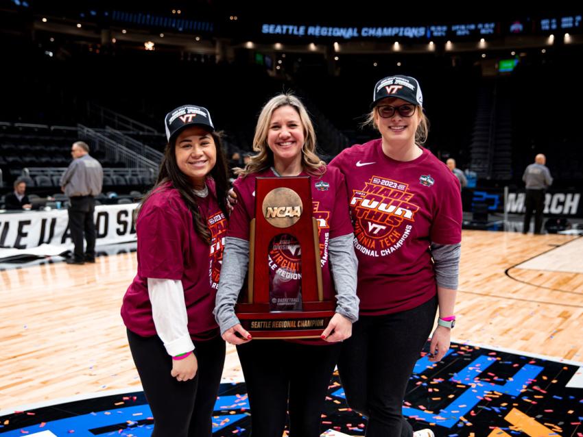 Mary Mitchell, DO posing with trophy after basketball game