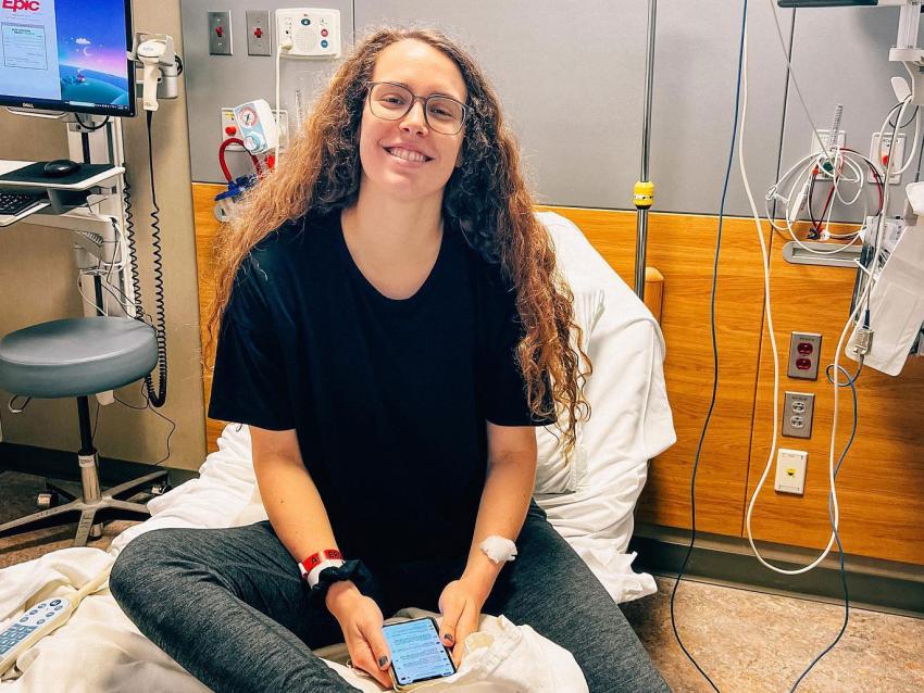 Ellie Greene sitting on a hospital bed