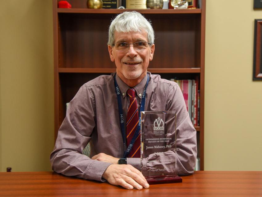 Jim Mahaney posing with award