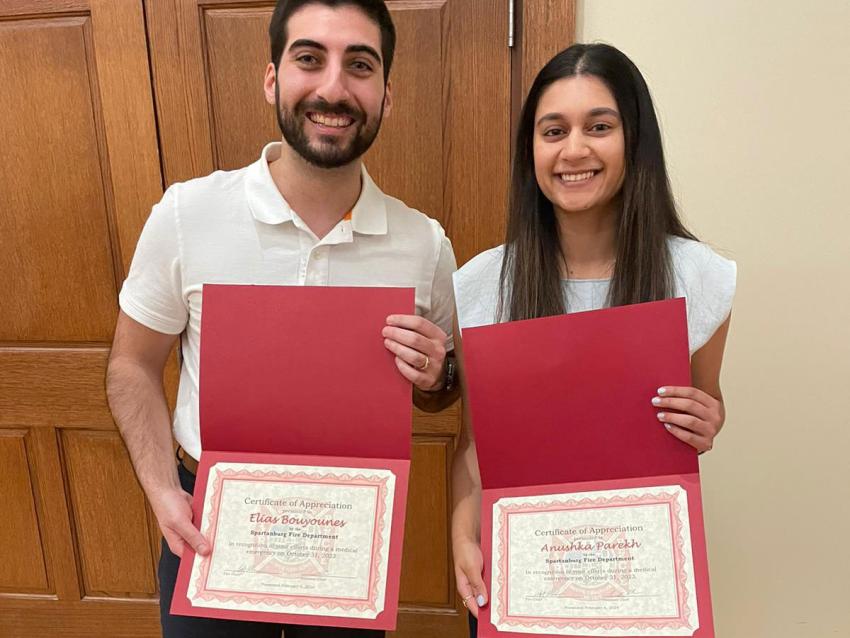 Anushka Parekh and Elias Bouyounes holding awards