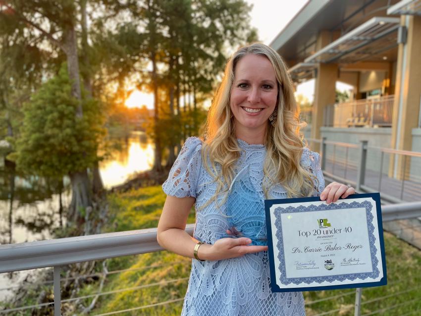 Dr. Carrie Baker-Royer with her Top 20 Under 40 Award