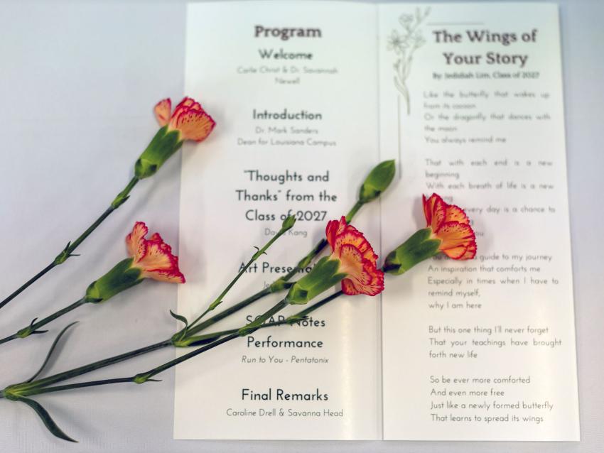 Flowers laying over a program for the donor ceremony