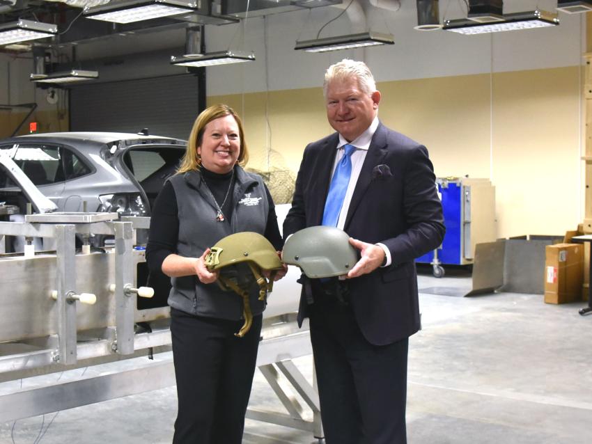 Dr Brolinson and Dr VandeVord holding helmets and smiling