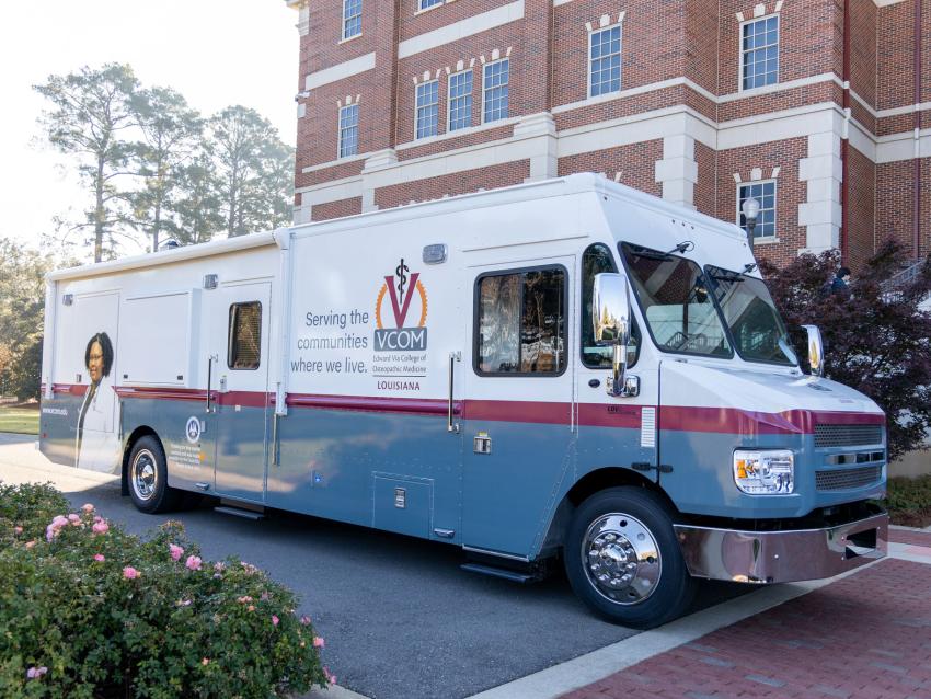 Mobile medical unit parked in front of VCOM-Louisiana campus building